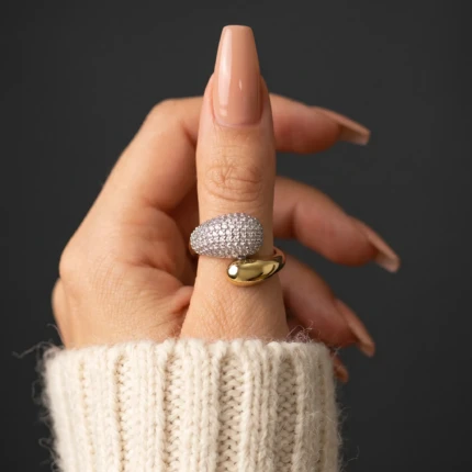 Woman wearing a gold-tone crystal wrap ring with sparkling stone detailing