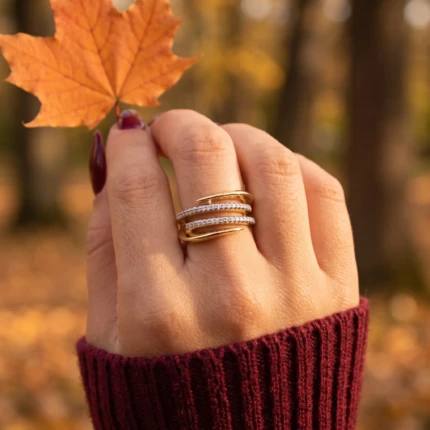 Woman wearing a gold-tone double crystal wrap statement ring