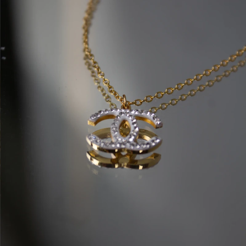 Gold-Tone Interlocking C Crystal Pendant Necklace for Women 3 Angled view of gold-tone interlocking crystal pendant necklace