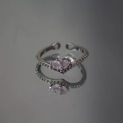 Front view of silver-tone pink butterfly ring with V-shaped crystal band