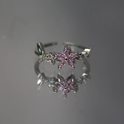 Front view of women’s silver-tone ring with pink crystal flower