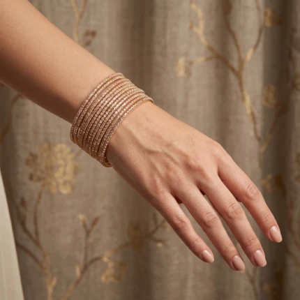 Elegant rose gold crystal bangles worn on a woman’s wrist in a luxury jewellery lifestyle setting