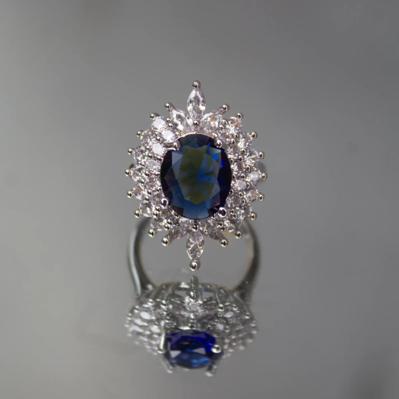 Silver-Tone Royal Blue Oval Crystal Statement Ring for Women 2 Front view of silver-tone ring with royal blue oval centre stone and clear crystal halo