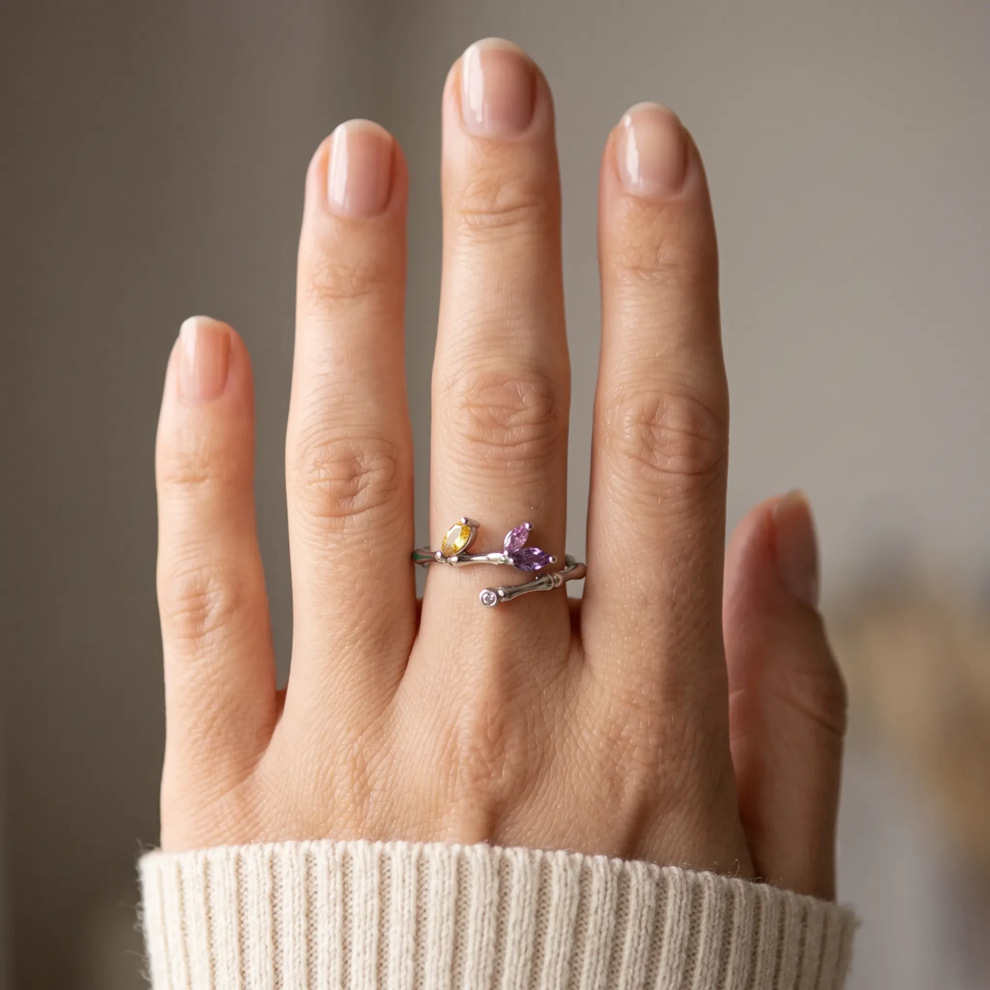 Silver-Tone Multicolor Crystal Leaf Ring for Women Woman wearing a silver-tone leaf ring with purple and yellow crystals