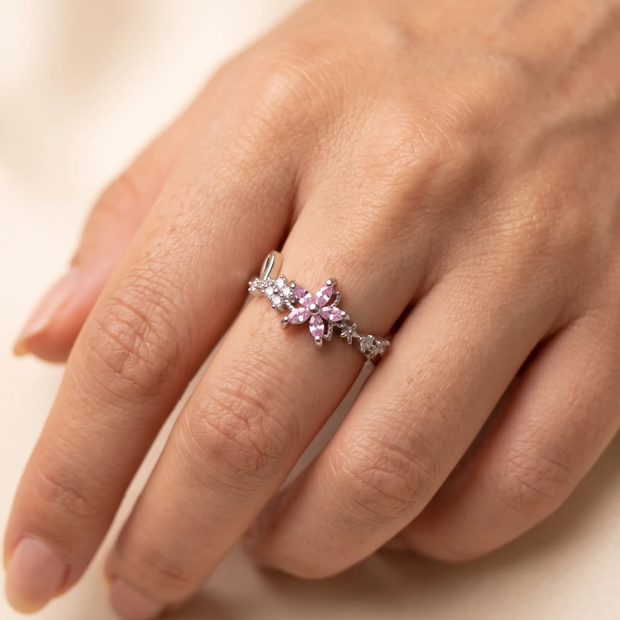 Silver-Tone Pink Crystal Flower Ring for Women Woman wearing a silver-tone pink crystal flower ring with clear stone accents